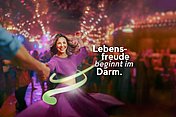 Hier sieht man das Keyvisual von MYRRHINIL-INTEST, eine tanzende Frau - Lebensfreude beginnt im Darm